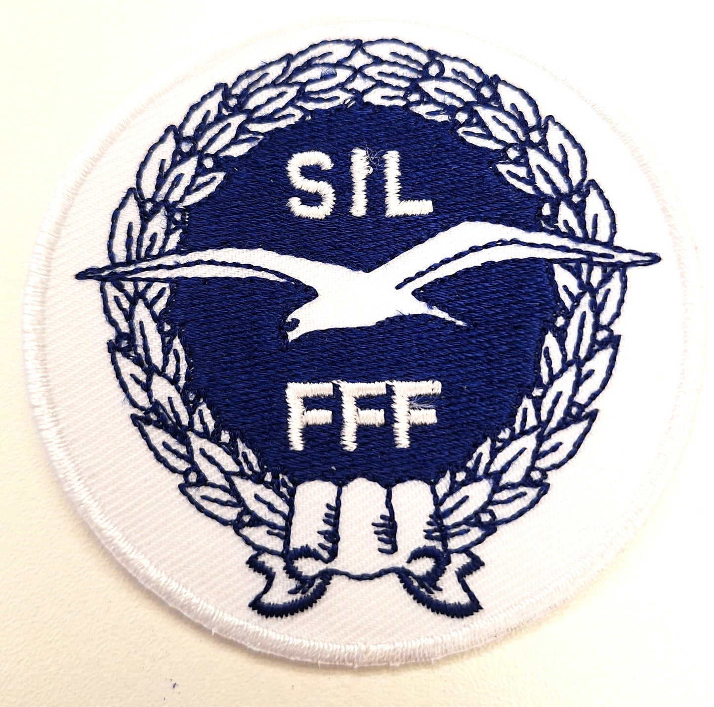 SIL-hihamerkki valkoinen